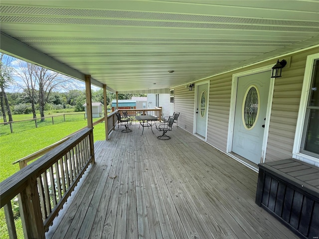 wooden terrace with a yard