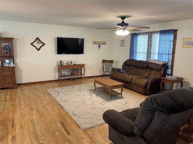 living room with light hardwood / wood-style floors and ceiling fan