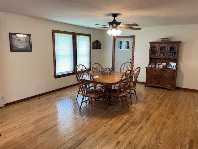 dining space featuring a textured ceiling, light hardwood / wood-style floors, and ceiling fan