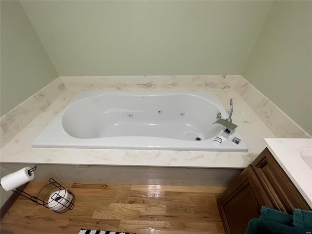 bathroom with vanity and a tub