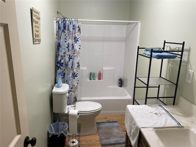 full bathroom with shower / tub combo with curtain, vanity, toilet, and hardwood / wood-style flooring