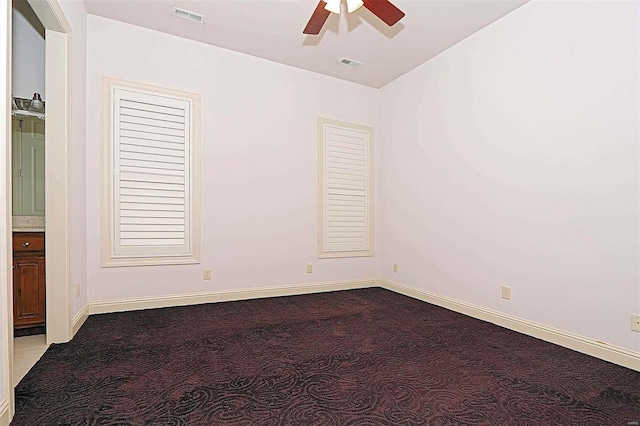 empty room with light colored carpet and ceiling fan