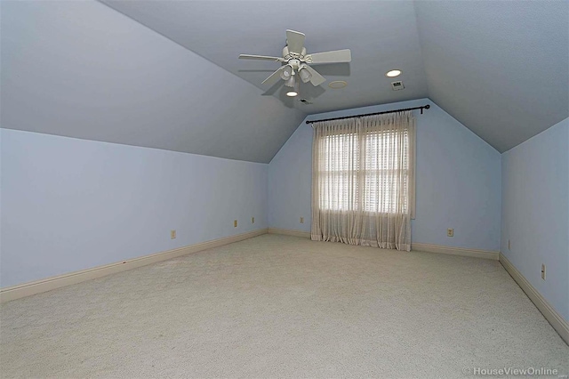 bonus room with vaulted ceiling, light carpet, and ceiling fan