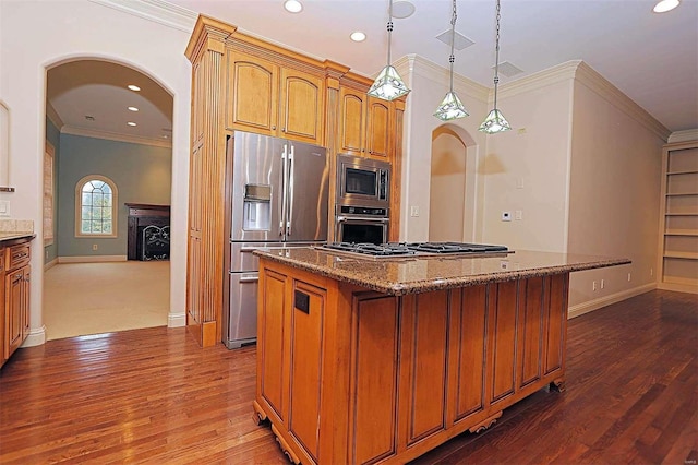 kitchen featuring a center island, appliances with stainless steel finishes, dark wood-type flooring, and crown molding