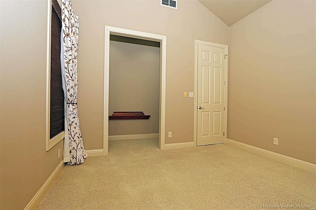 interior space featuring vaulted ceiling and carpet flooring