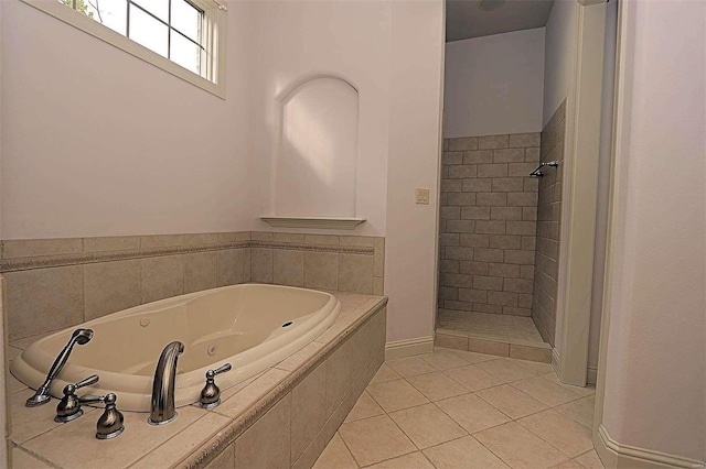 bathroom featuring shower with separate bathtub and tile patterned flooring