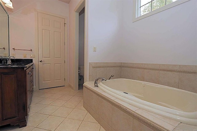 bathroom featuring vanity, tile patterned flooring, and tiled tub