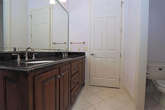 bathroom featuring vanity, toilet, and tile patterned floors