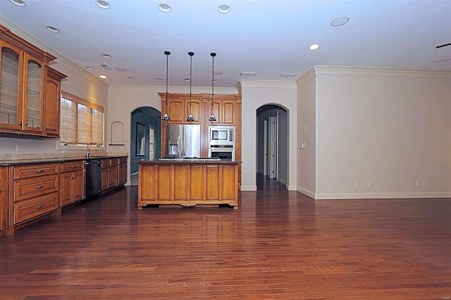 kitchen featuring appliances with stainless steel finishes, crown molding, decorative light fixtures, and dark hardwood / wood-style flooring