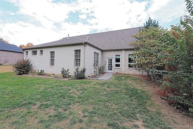 rear view of house with a lawn