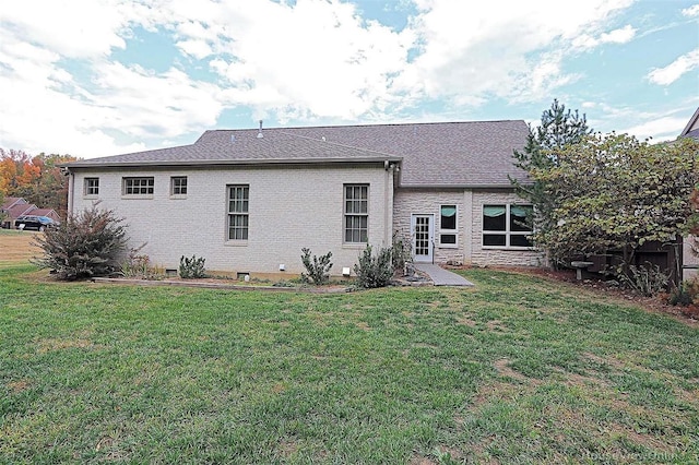 back of property featuring a patio area and a lawn