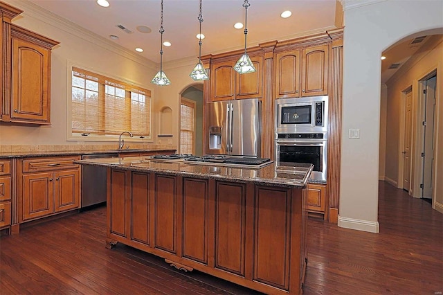 kitchen with pendant lighting, a center island, stainless steel appliances, and dark hardwood / wood-style floors