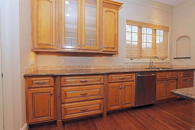 kitchen featuring stainless steel dishwasher, dark stone counters, dark hardwood / wood-style floors, crown molding, and sink