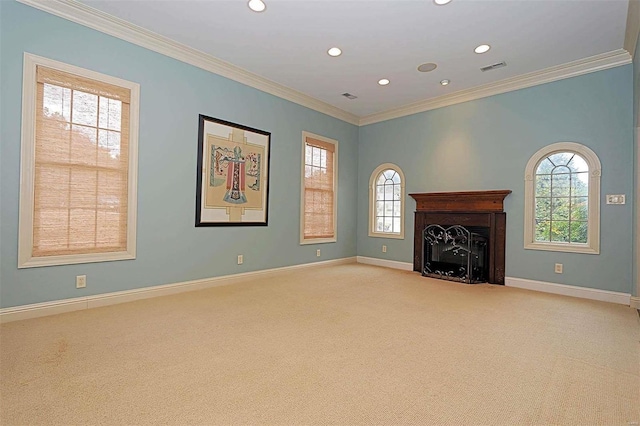 unfurnished living room with ornamental molding, light colored carpet, and plenty of natural light