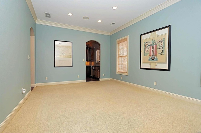 carpeted empty room featuring ornamental molding