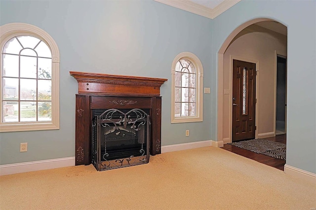 unfurnished living room with crown molding and hardwood / wood-style floors