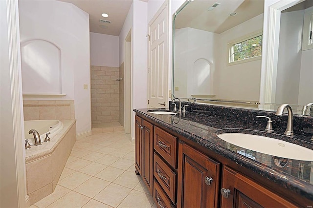 bathroom featuring vanity, shower with separate bathtub, and tile patterned flooring