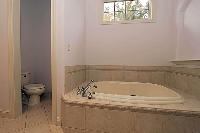 bathroom featuring toilet, tile patterned floors, and tiled bath