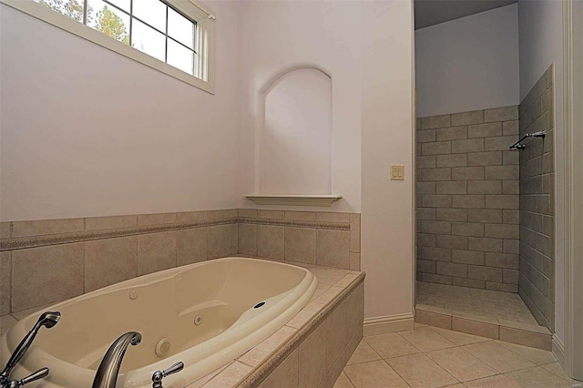 bathroom with plus walk in shower and tile patterned flooring