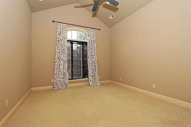 empty room with ceiling fan, carpet, and vaulted ceiling