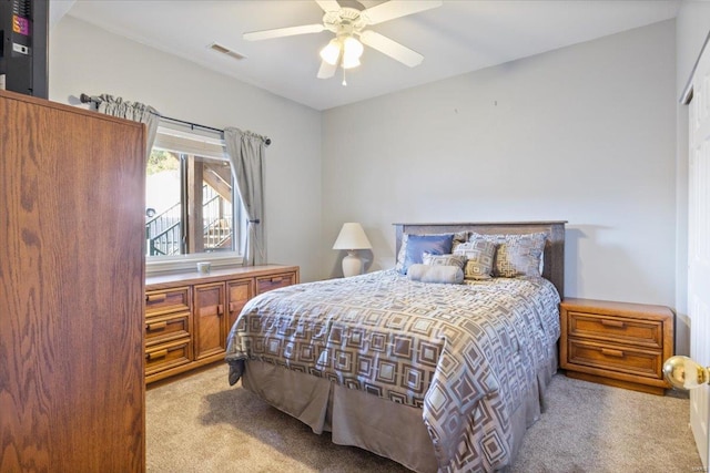 bedroom with light carpet and ceiling fan