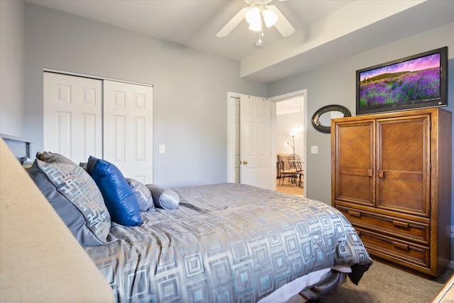 carpeted bedroom featuring ceiling fan and a closet