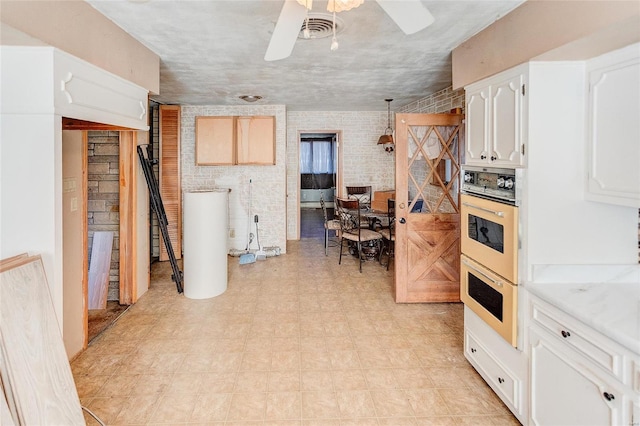 kitchen featuring white cabinets, hanging light fixtures, white double oven, water heater, and ceiling fan