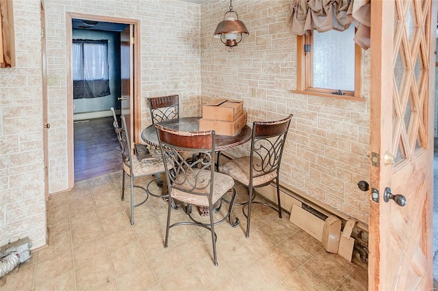 dining area featuring brick wall