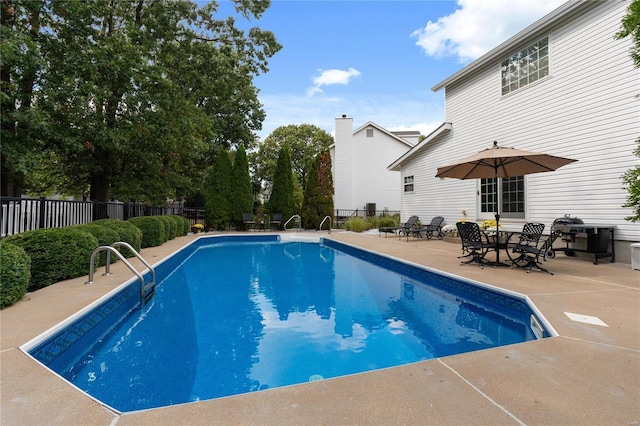 view of swimming pool with a patio