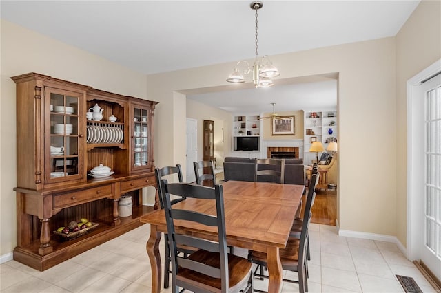 dining space featuring light tile patterned floors and a chandelier