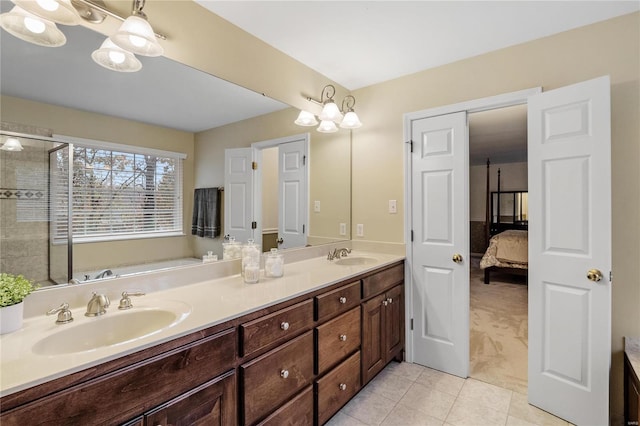 bathroom with tile patterned flooring, vanity, and a shower with shower door