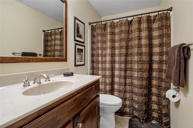 bathroom featuring tile patterned floors, vanity, and toilet