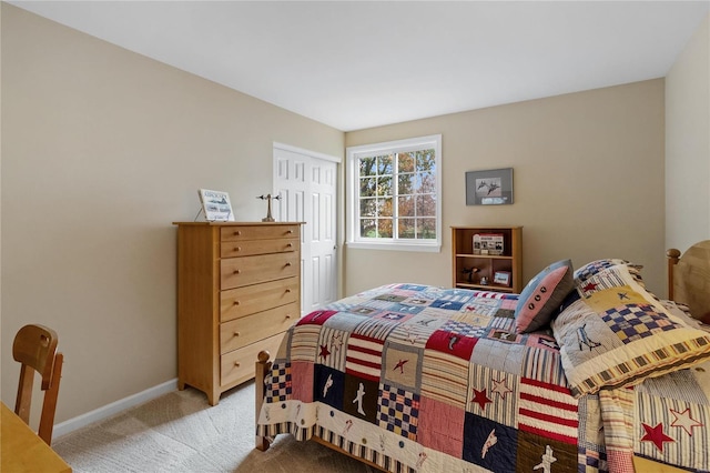 bedroom featuring a closet and light carpet