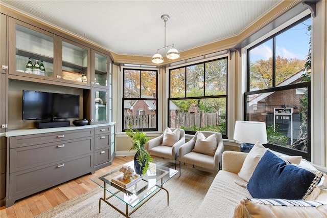 sunroom / solarium with a wealth of natural light and a chandelier