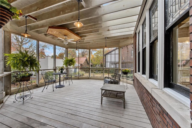 unfurnished sunroom with ceiling fan