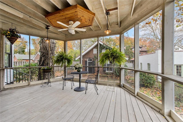 sunroom featuring ceiling fan, beam ceiling, and wooden ceiling