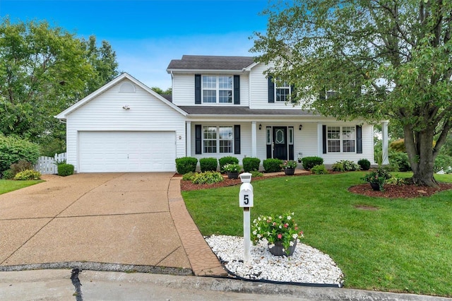 view of property featuring a front lawn and a garage