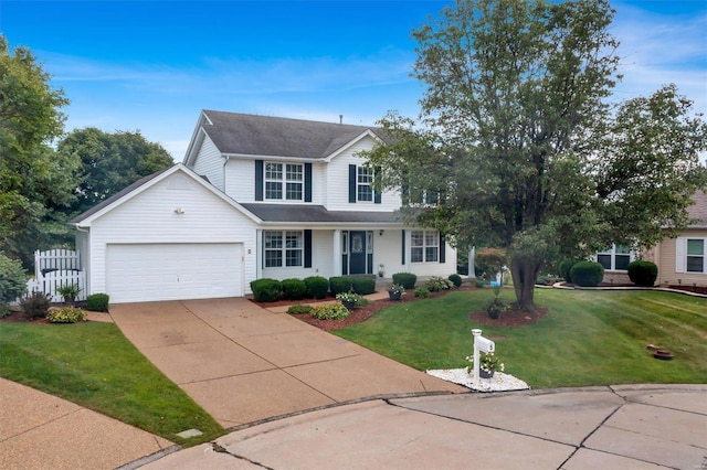 view of front of home with a front yard and a garage