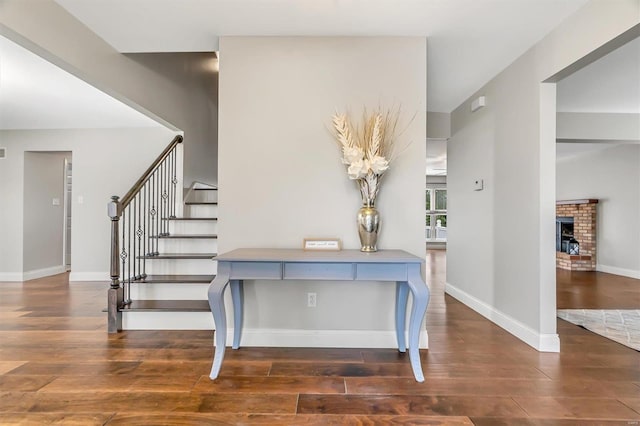 interior space featuring a fireplace and dark hardwood / wood-style flooring