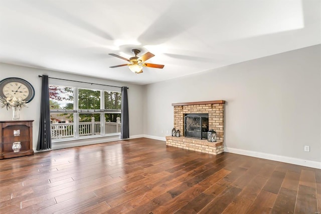 unfurnished living room featuring ceiling fan, a fireplace, and dark wood-type flooring