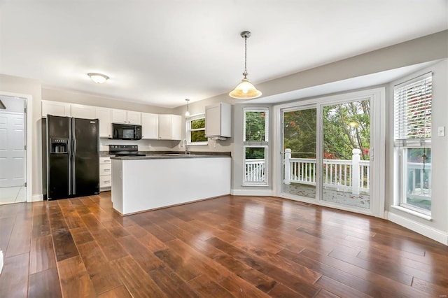 kitchen with black appliances, white cabinetry, dark hardwood / wood-style flooring, and decorative light fixtures