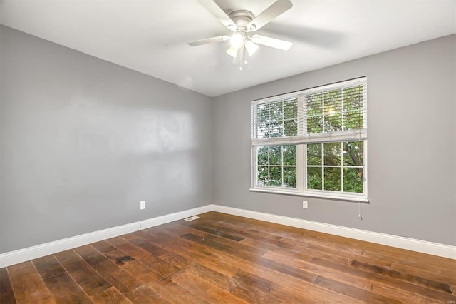 unfurnished room with ceiling fan and dark hardwood / wood-style flooring