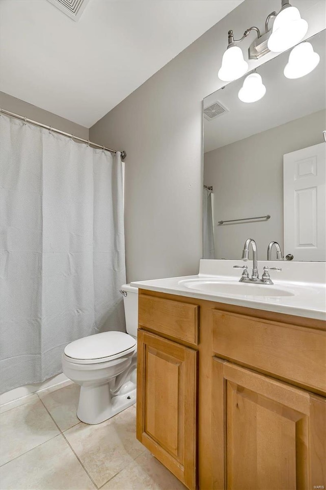 bathroom with curtained shower, tile patterned flooring, vanity, and toilet