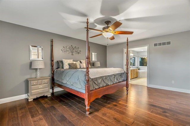 bedroom featuring dark hardwood / wood-style floors, ceiling fan, and ensuite bath