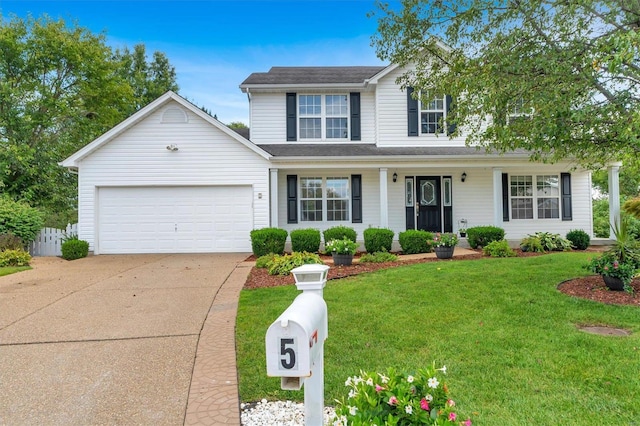 view of front of home with a front yard, a garage, and a porch