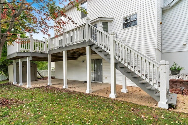 back of property featuring a lawn, a patio, and a deck