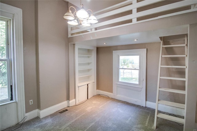 interior space featuring a chandelier and carpet