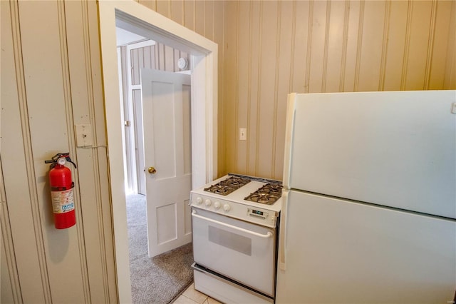 kitchen with white appliances and light tile patterned floors