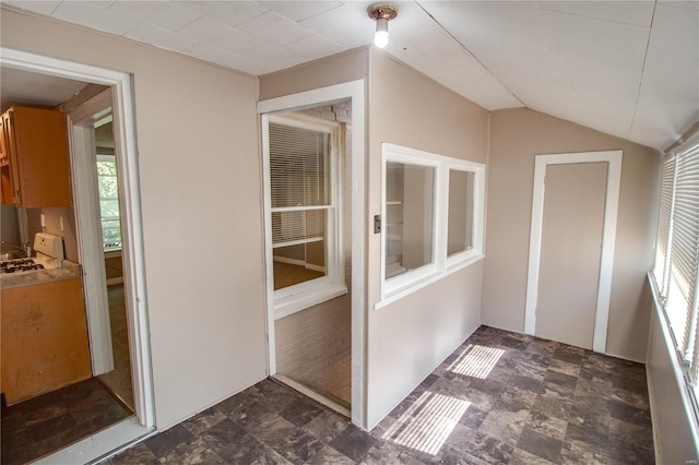 unfurnished sunroom featuring lofted ceiling