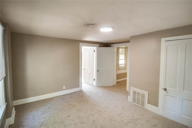 unfurnished bedroom featuring light colored carpet